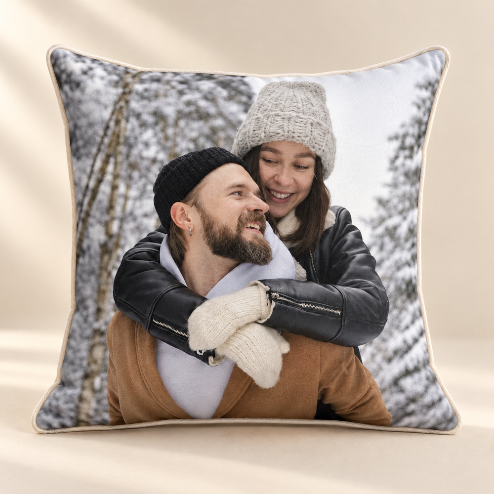 Square custom photo pillow with a winter couple portrait on a warm beige backdrop.