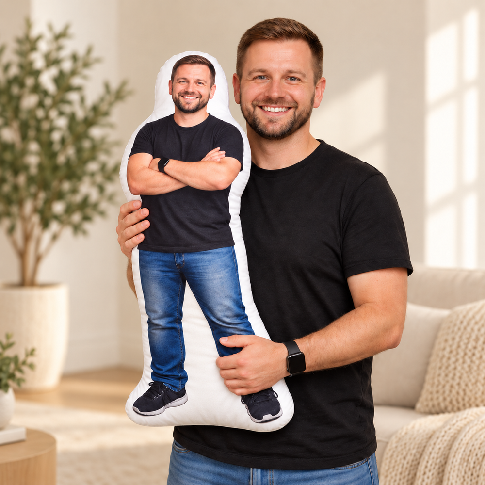 Man holding a one-piece person photo pillow with a continuous fabric base joining the printed legs.